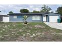 Charming single-story home with a blue exterior, manicured lawn, and attached garage at 31 S Edgemon Ave, Winter Springs, FL 32708