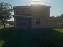Exterior back view of home with large lawn and back porch at 3102 Westbrook Rd, Kissimmee, FL 34746