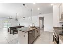 Bright kitchen open to the dining area, featuring granite countertops and stainless steel appliances at 33263 Rembrandt Ln, Sorrento, FL 32776