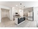 Modern kitchen featuring granite countertops, stainless steel appliances, and a center island with pendant lighting at 33263 Rembrandt Ln, Sorrento, FL 32776