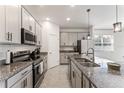 Well-equipped kitchen with granite countertops, stainless steel appliances, and ample cabinet space at 33263 Rembrandt Ln, Sorrento, FL 32776