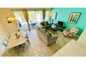 Open-concept living space flows out to the pool area with comfortable seating and decor at 349 Captiva Dr, Davenport, FL 33896
