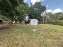 Large backyard with covered porch, mature trees and plenty of green space at 3535 Island Oaks N, Lakeland, FL 33805