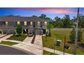 An aerial view of a two-story townhome featuring a manicured lawn and driveway at 3617 Anibal St, Kissimmee, FL 34746