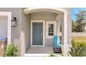 Inviting front door with a charming blue chair, a 'Private Residence' sign, and tropical landscaping at 3617 Anibal St, Kissimmee, FL 34746