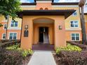 Inviting condo entrance with stairs, well-lit entryway, and a directory for easy navigation at 5451 Vineland Rd # 111, Orlando, FL 32811