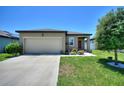 Attractive single-Gathering home with a neat front yard, two-car garage, and welcoming curb appeal at 5816 Beefmaster Rd, St Cloud, FL 34771