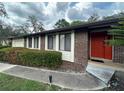 Charming exterior view featuring brick and siding, complemented by lush landscaping and a walkway at 585 Mourning Dove Cir, Lake Mary, FL 32746