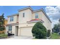 Attractive two-story home boasting a red tile roof, neutral stucco and a well-maintained yard at 6041 Broad Oak Dr, Davenport, FL 33837