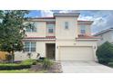 Beautiful two-story home featuring a red tile roof, neutral stucco and a well-manicured yard at 6041 Broad Oak Dr, Davenport, FL 33837