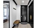 Elegant entryway with a black door, stylish bench, and modern accents at 7503 Mourning Dove Cir # 101, Reunion, FL 34747