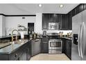 Stylish kitchen featuring stainless steel appliances and granite countertops with ample cabinet space at 7503 Mourning Dove Cir # 101, Reunion, FL 34747