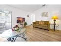 Inviting living room with wood floors, comfortable seating, and sliding glass door access to the outdoor patio at 7807 Turkey Oak Ln, Kissimmee, FL 34747