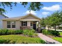 Charming single-story home with stone accents, manicured landscaping and a brick walkway leading to the front door at 8262 Bayview Crossing Dr, Winter Garden, FL 34787
