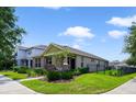 Charming single-story home with stone accents, manicured landscaping and a fenced front yard at 8262 Bayview Crossing Dr, Winter Garden, FL 34787