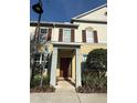 Charming two-story townhouse with a welcoming front porch and well-maintained landscaping at 8271 Maritime Flag St # 109, Windermere, FL 34786