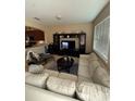 Spacious living room with large windows, comfortable seating, and a built-in entertainment center at 8271 Maritime Flag St # S, Windermere, FL 34786