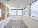 Sunroom with beautiful patterned tile floor, white walls, and lots of natural light at 1007 11Th St, St Cloud, FL 34769