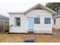 Quaint single-story home with a light blue front door, freshly painted white exterior, and new landscaping at 1007 11Th St, St Cloud, FL 34769