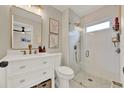 Updated bathroom with a glass enclosed shower, modern fixtures, and white vanity at 1050 Dees Dr, Oviedo, FL 32765