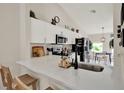 Bright kitchen with stainless steel appliances, quartz countertops, and a breakfast bar at 1050 Dees Dr, Oviedo, FL 32765