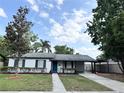 Charming single-story home featuring black shutters, fresh landscaping, and a convenient covered carport at 1098 Leeway Ct, Orlando, FL 32810