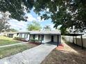 Charming single-story home with black shutters and a convenient covered carport and long driveway at 1098 Leeway Ct, Orlando, FL 32810