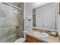 Neutral bathroom featuring a glass enclosed shower, single vanity, and white toilet at 1103 Cypress Pointe Blvd, Davenport, FL 33896