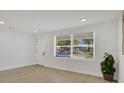 Bright bedroom with wood flooring, a large window, and fresh paint, creating a serene retreat at 118 Deacon Jones Blvd, Orlando, FL 32810