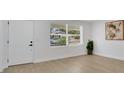 Bright bedroom with wood flooring, a large window, and freshly painted walls, creating a serene retreat at 118 Deacon Jones Blvd, Orlando, FL 32810