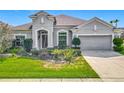 Inviting single-story home with well-kept lawn, complemented by an attached two-car garage at 12313 Prairie Plantation Way, Orlando, FL 32824