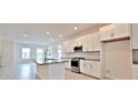 Bright, spacious kitchen featuring white cabinets, island with granite countertops, and stainless steel appliances at 12537 Encore At Ovation Way, Winter Garden, FL 34787