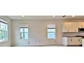 Bright living room with large windows and a view of the street, next to the kitchen at 12537 Encore At Ovation Way, Winter Garden, FL 34787