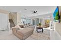 Bright open-plan living room featuring tile flooring, large sectional sofa, and sliding glass doors at 1428 Reunion Blvd, Kissimmee, FL 34747