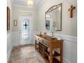 Welcoming foyer with elegant wainscoting and stylish console table at 1631 Nina Dr, Davenport, FL 33837