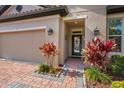 Inviting front entrance with brick walkway and lush landscaping at 1631 Nina Dr, Davenport, FL 33837