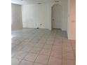 Bright, tiled living room featuring neutral walls and ample natural light at 1828 Buckeye Rd, Davenport, FL 33837