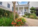 Charming entrance with a column-lined porch, beautiful landscaping, and a welcoming white front door at 202 Acadia Ter, Kissimmee, FL 34747