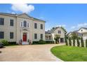 Stunning two-story home with a red front door, winding driveway, and manicured lawn and garden at 202 Acadia Ter, Kissimmee, FL 34747