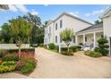 Elegant exterior showcasing a circular driveway, manicured landscaping, and a charming portico entrance at 202 Acadia Ter, Kissimmee, FL 34747