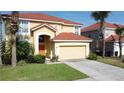 Inviting two-story home with a terra-cotta tiled roof, attached garage, and well-maintained front yard at 219 Rosso Dr, Davenport, FL 33837