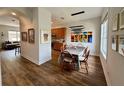 Elegant dining area featuring wood floors, a modern light fixture, and abundant natural light at 2287 Park Maitland Ct, Maitland, FL 32751