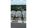 Aerial view of the two-story home showcasing its manicured lawn, blue garage, and neighborhood setting at 2386 Rama Dr, Kissimmee, FL 34746