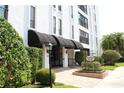 Inviting building entrance with awnings, lush landscaping, and a clear directory at 265 E Canton Ave # Ge, Winter Park, FL 32789
