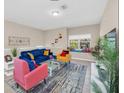 Comfortable living room featuring stylish furniture, including sofa, chairs, and a cozy ambiance at 2736 Oakwater Dr, Kissimmee, FL 34747