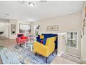 Bright living room featuring a sofa, chairs, and an open dining area with abundant natural light at 2736 Oakwater Dr, Kissimmee, FL 34747