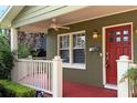 Charming front porch showcases a red door and white railing at 2810 Elizabeth Ave, Orlando, FL 32804