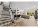 Open-concept entry featuring a staircase, modern light fixture, dining area and spacious living room with lots of light at 2821 Columbus Ave, Clermont, FL 34715