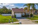 Charming single-story home with a two-car garage, and well-maintained landscaping at 2902 Paddington Way, Kissimmee, FL 34747