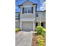 Townhome showcasing a one-car garage and well-maintained front yard at 3151 Sinclair St # 104, Orlando, FL 32835